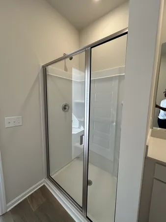 a bathroom with a glass shower door
