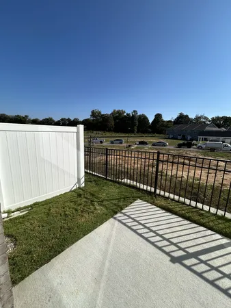 a view of a wooden fence and a yard