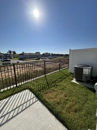 a view of balcony with wooden floor and fence