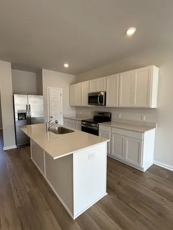 a kitchen with stainless steel appliances a refrigerator sink and cabinets