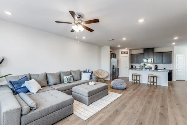 a living room with furniture and kitchen view