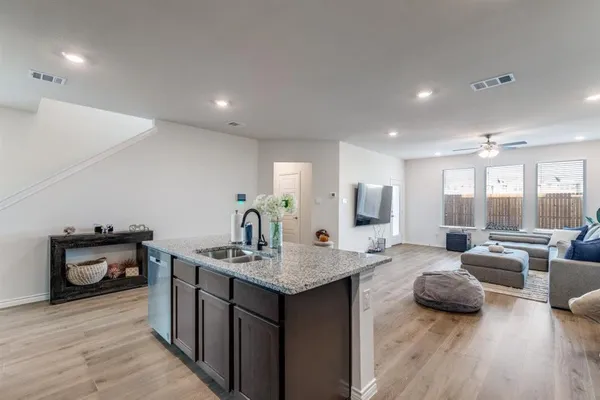 a open kitchen with stainless steel appliances granite countertop a lot of counter space and wooden floor