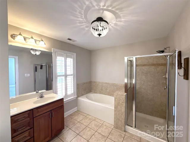 a bathroom with a bathtub a sink and a mirror