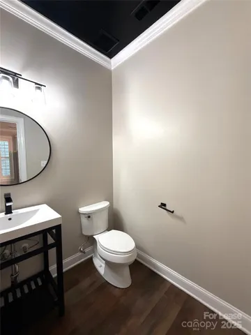 a bathroom with a toilet a sink and a mirror