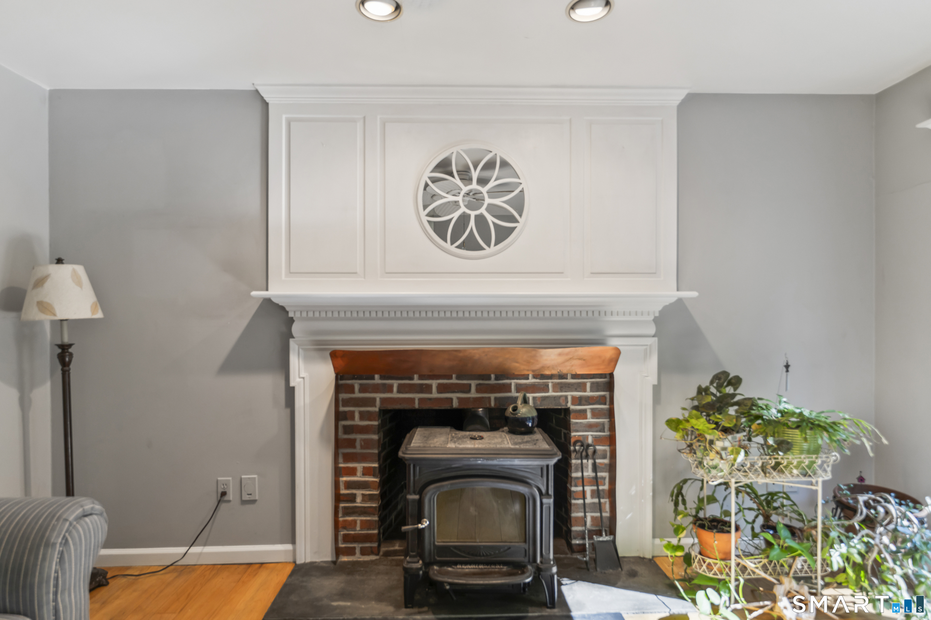 18 Gelding Hill Road Newtown, CT 06482 - Photo 16 of 40 a living room with a fireplace and a potted plant