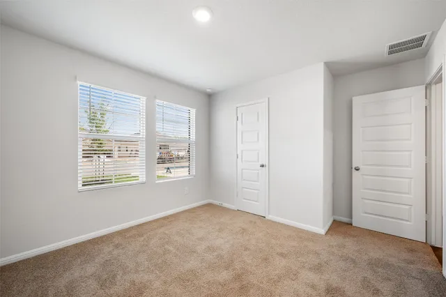 a bathroom with a sink a toilet and a large mirror