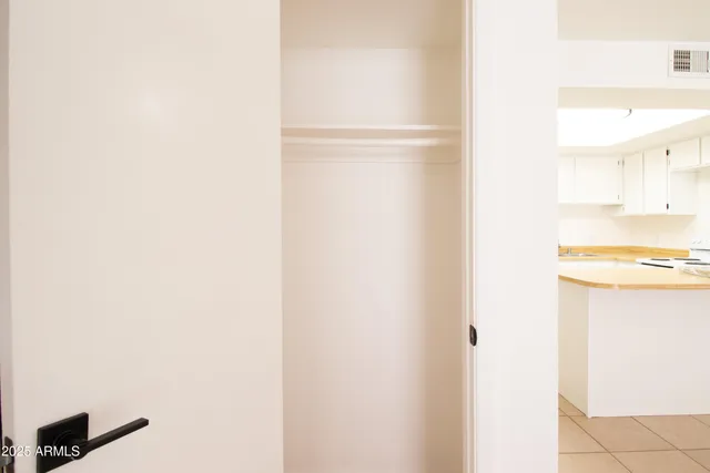 a view of walk in closet with empty racks