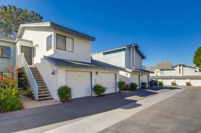 a view of a street with a house in the background