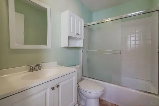 a bathroom with a glass shower door