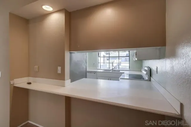 a large white kitchen with a large window