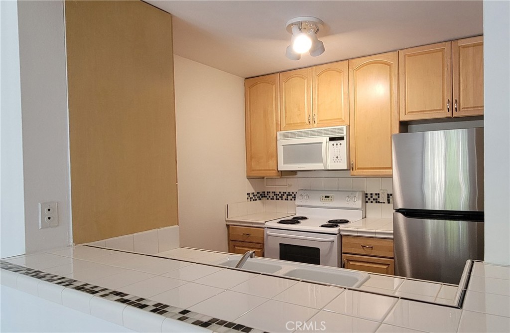 8740 Tuscany Avenue Playa del Rey, CA 90293 - Photo 8 of 21 a kitchen with stainless steel appliances a stove and a refrigerator