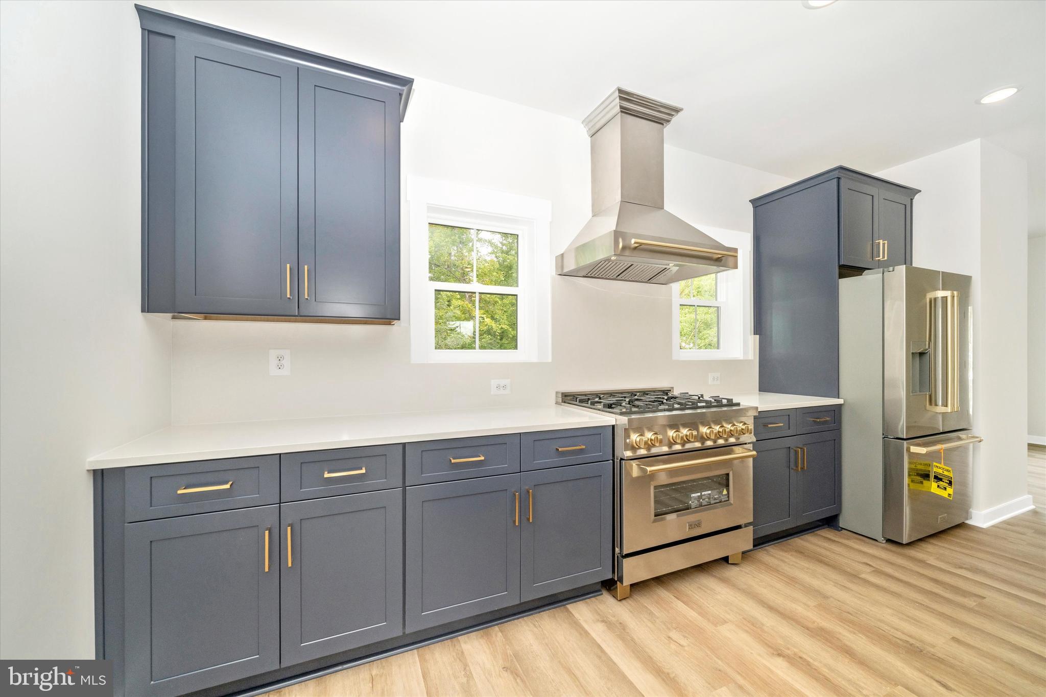 203 Riverside Drive Chester, MD 21619 - Photo 14 of 68 a kitchen with stainless steel appliances granite countertop a stove a refrigerator and a refrigerator