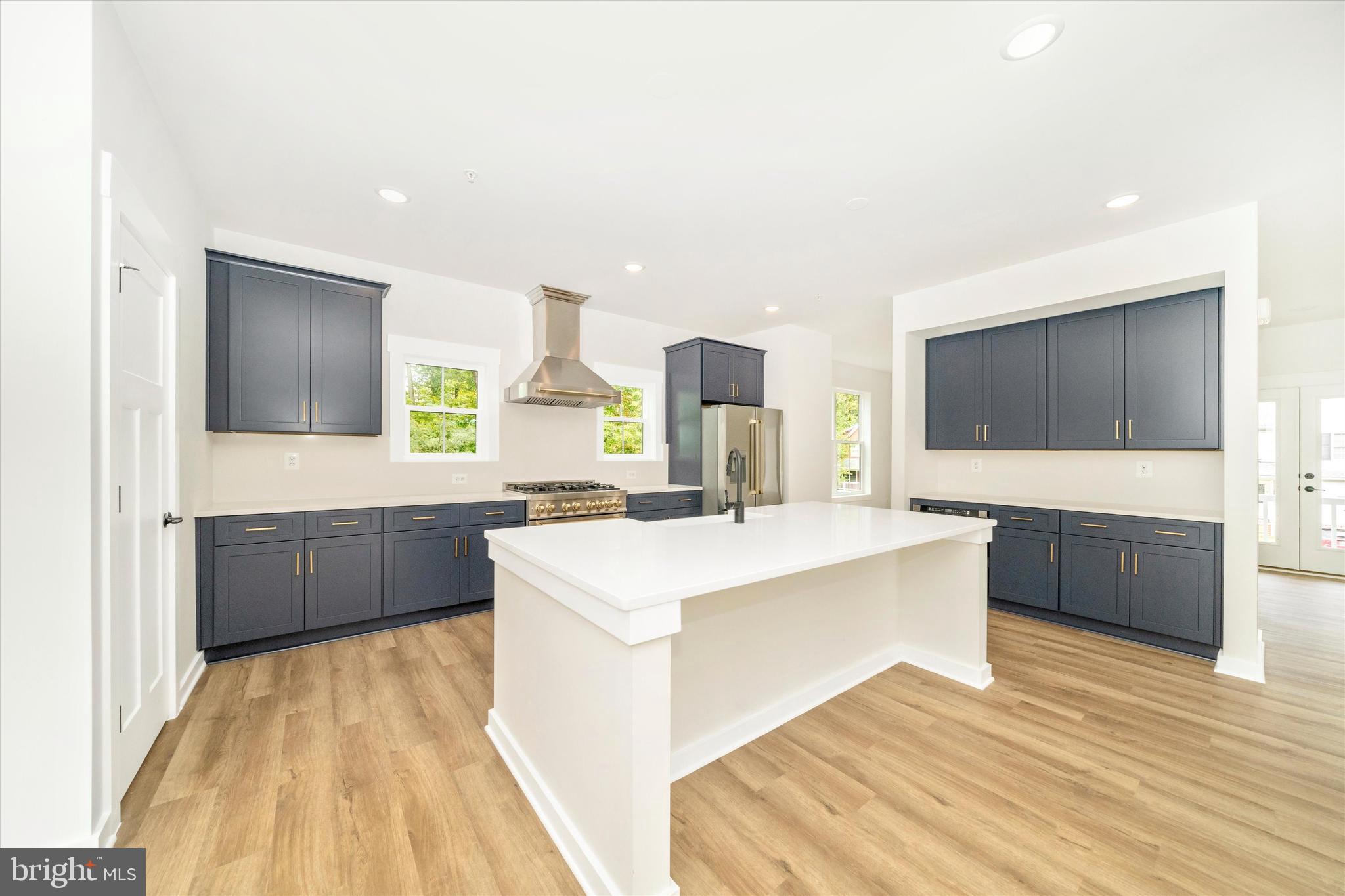 203 Riverside Drive Chester, MD 21619 - Photo 15 of 68 a large white kitchen with a large window a sink and counter space