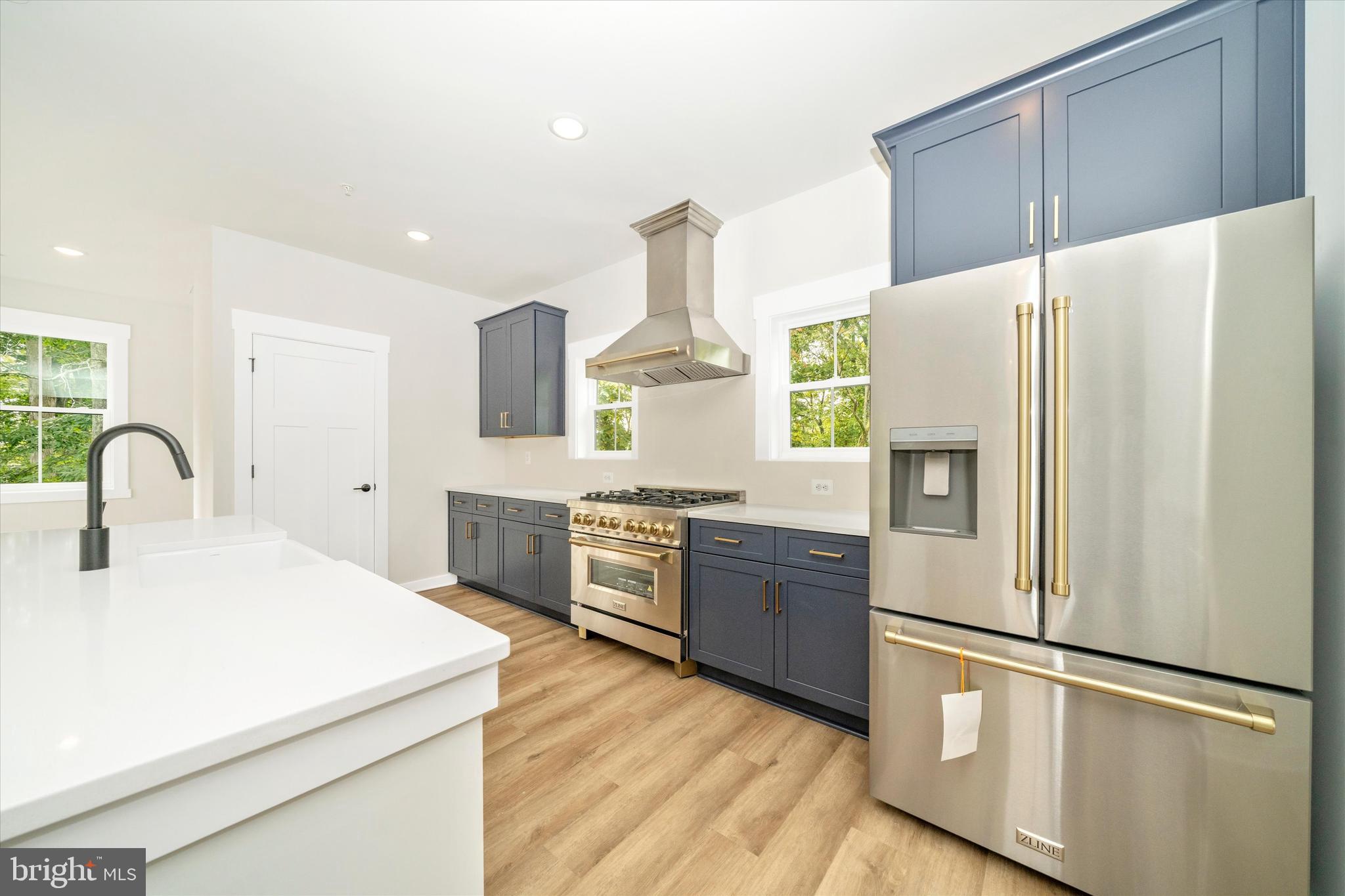 203 Riverside Drive Chester, MD 21619 - Photo 16 of 68 a kitchen with stainless steel appliances a refrigerator sink and cabinets