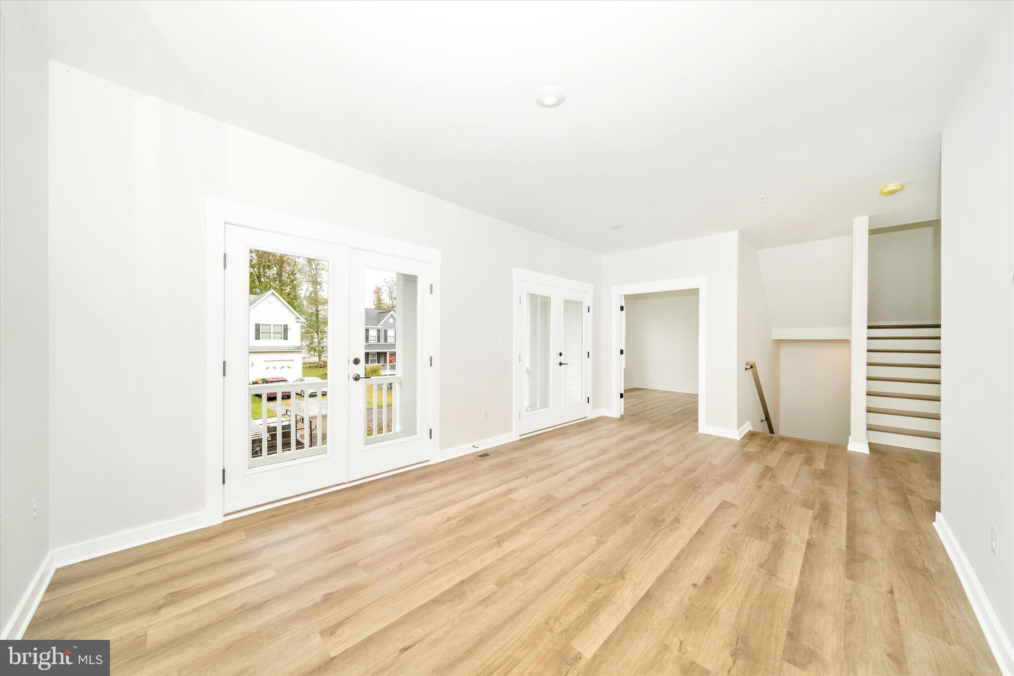 203 Riverside Drive Chester, MD 21619 - Photo 19 of 68 a view of an empty room with wooden floor and a window