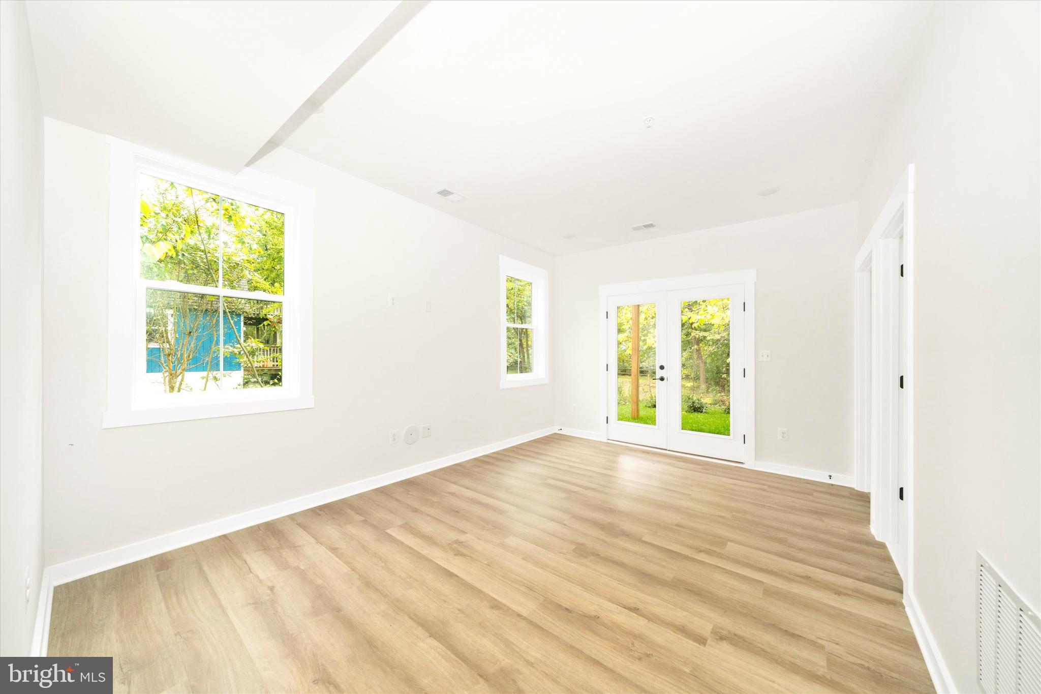 203 Riverside Drive Chester, MD 21619 - Photo 23 of 68 a view of an empty room with wooden floor and a window