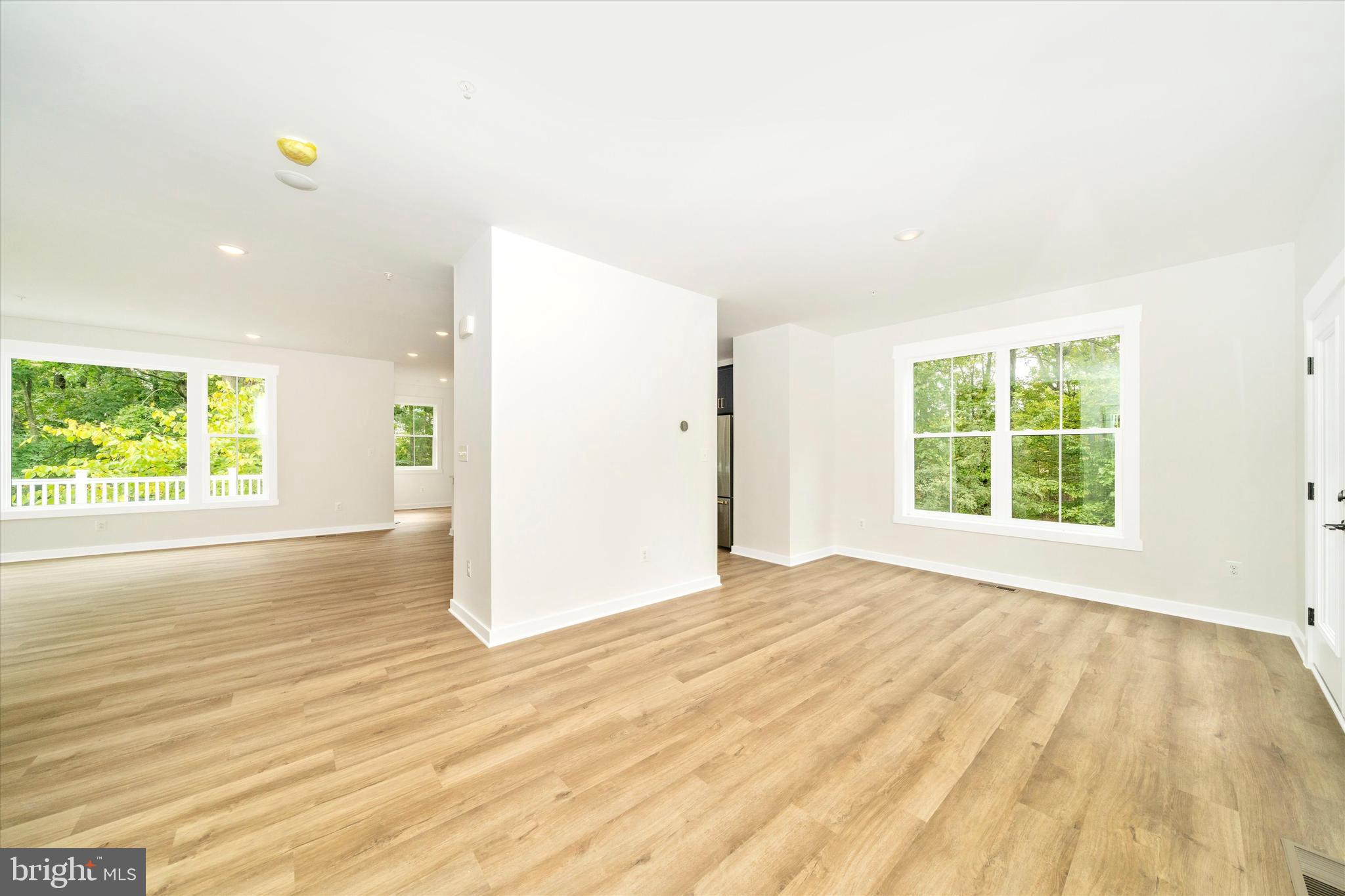 203 Riverside Drive Chester, MD 21619 - Photo 29 of 68 a view of an empty room with wooden floor and a window