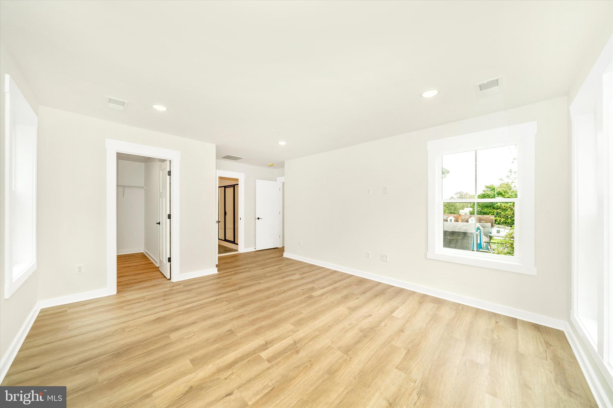 203 Riverside Drive Chester, MD 21619 - Photo 54 of 68 a view of an empty room with wooden floor and a window