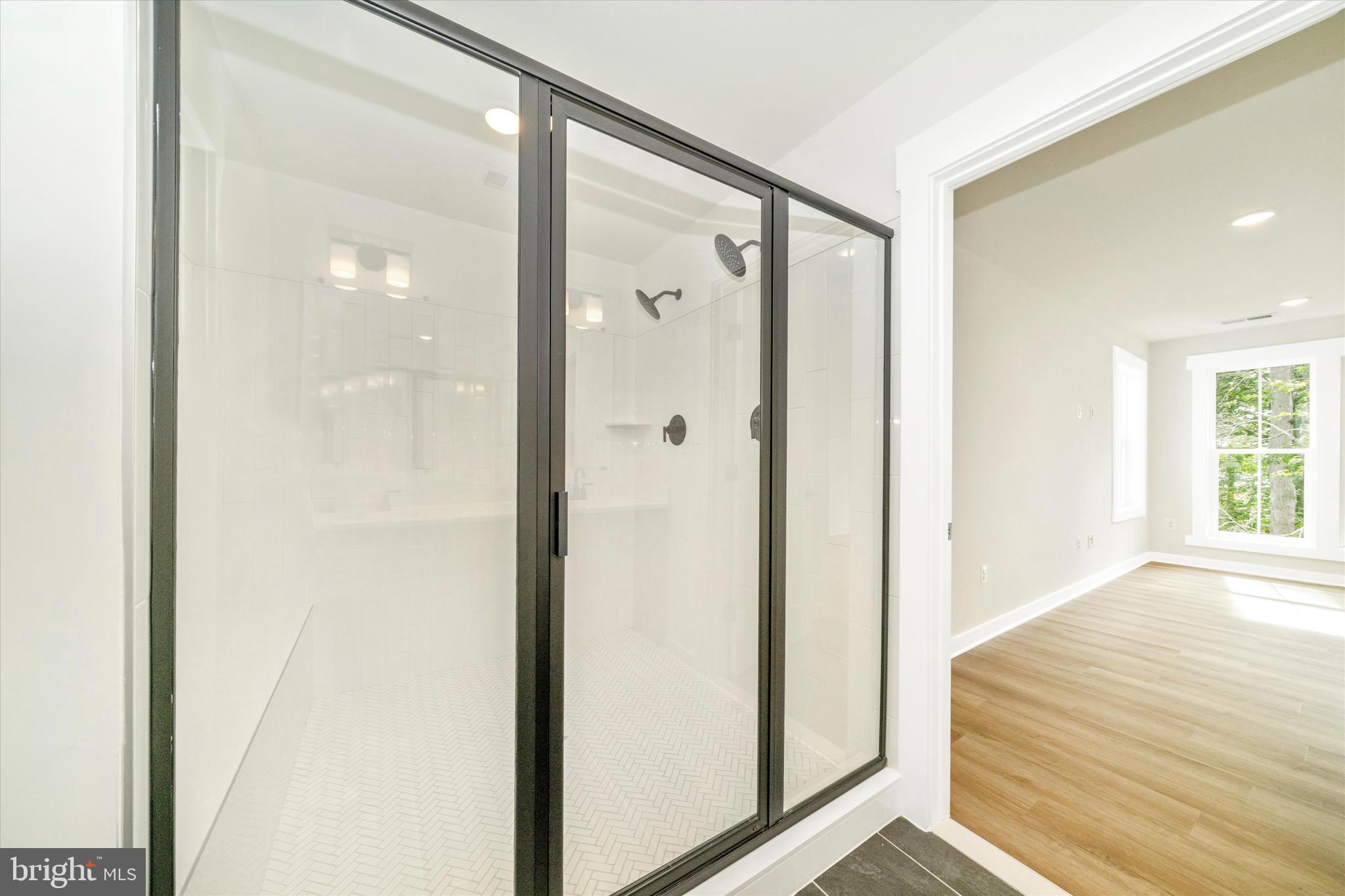 203 Riverside Drive Chester, MD 21619 - Photo 56 of 68 a bathroom with a shower and a glass door