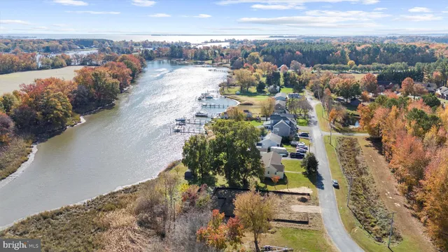 a large white kitchen with a large window a sink and counter space
