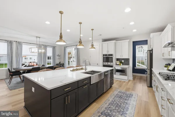 a kitchen with stainless steel appliances kitchen island granite countertop a sink stove and cabinets