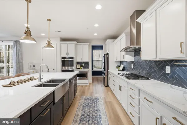 a kitchen with a dining table chairs and cabinets