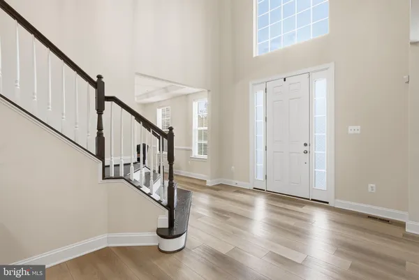 a view of entryway and hall with wooden floor