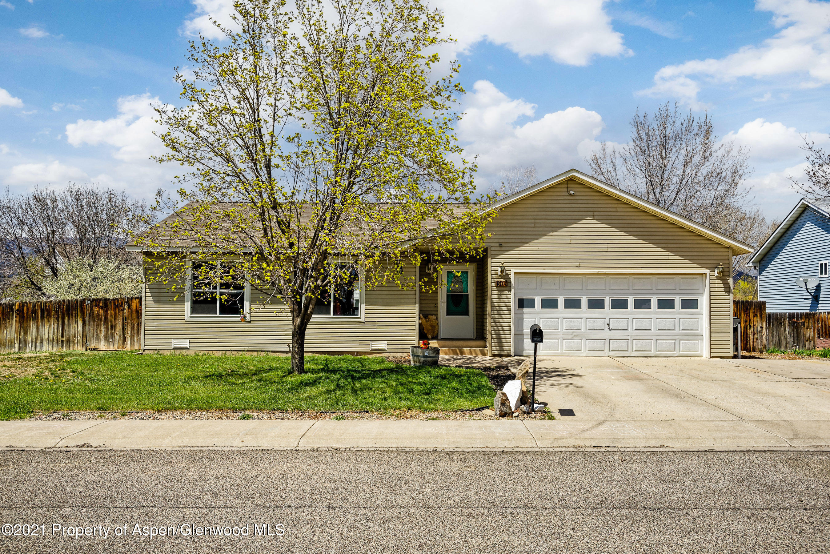 1503 Beech Street Rifle, CO 81650 - Photo 1 of 8 a front view of a house with a yard