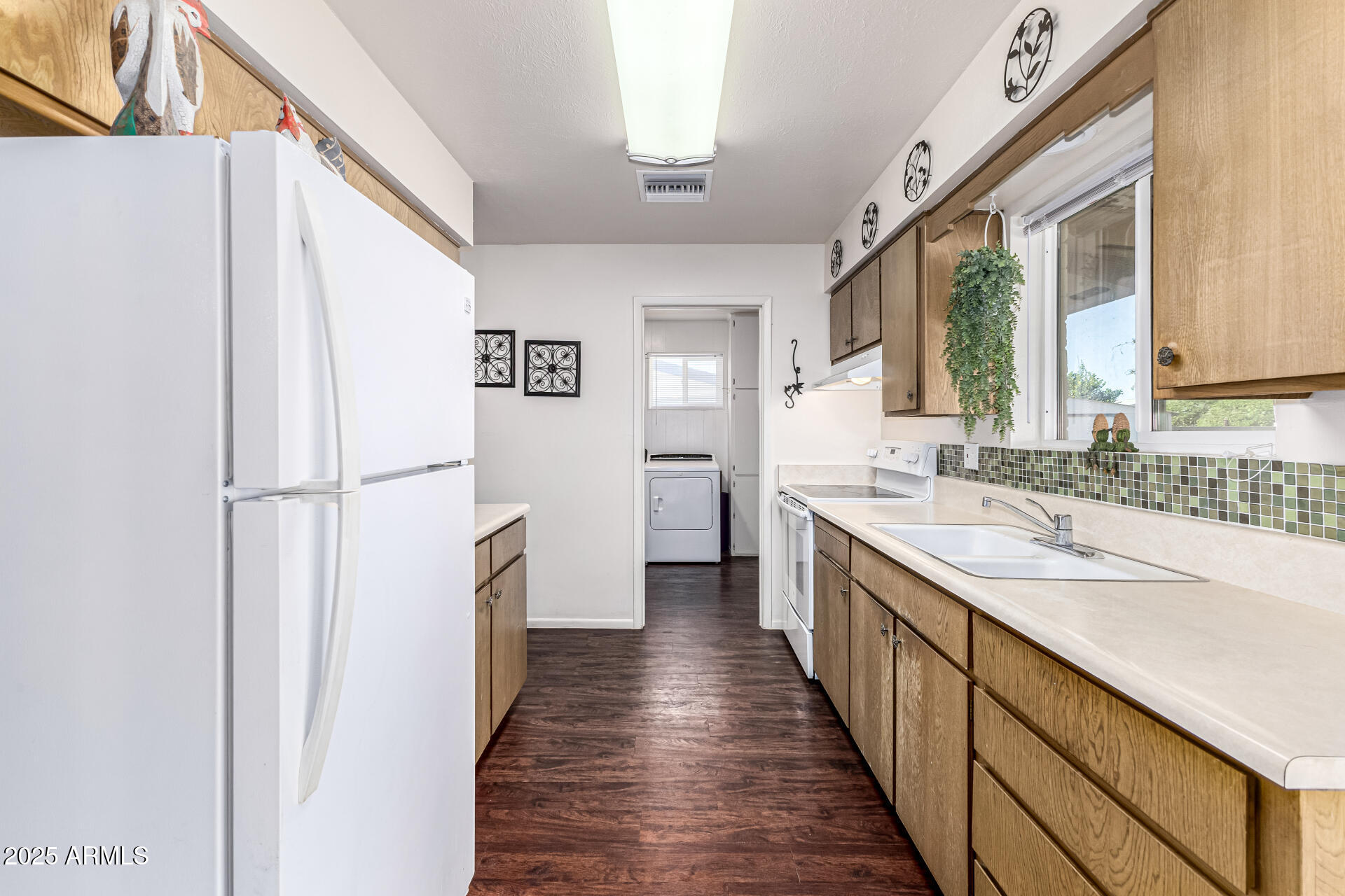 6256 East Decatur Street Mesa, AZ 85205 - Photo 15 of 28 a kitchen with a sink and refrigerator