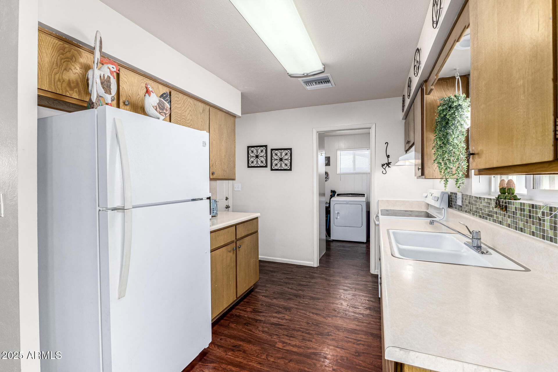6256 East Decatur Street Mesa, AZ 85205 - Photo 16 of 28 a white refrigerator freezer sitting inside of a kitchen