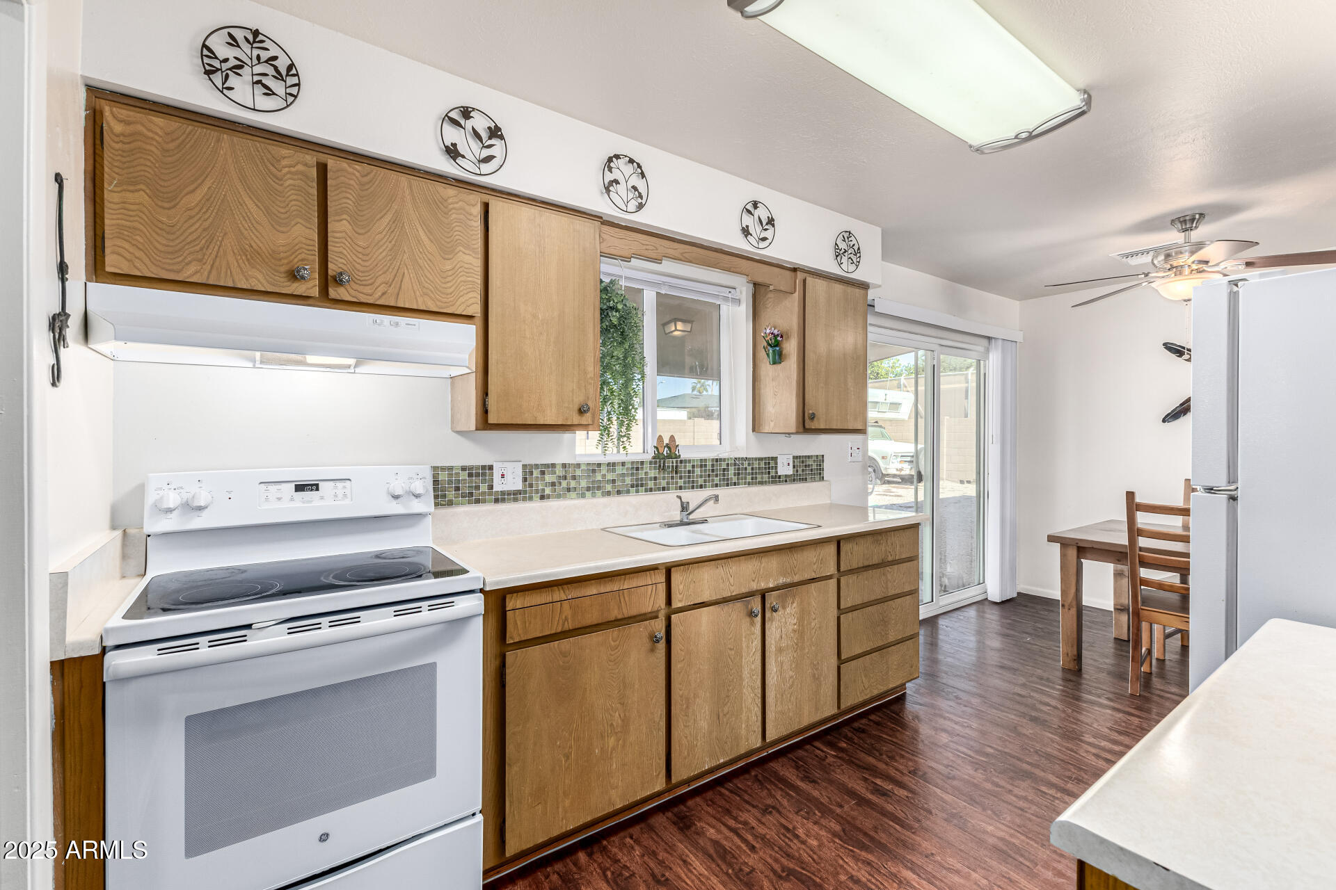 6256 East Decatur Street Mesa, AZ 85205 - Photo 18 of 28 a kitchen with a sink cabinets and wooden floor