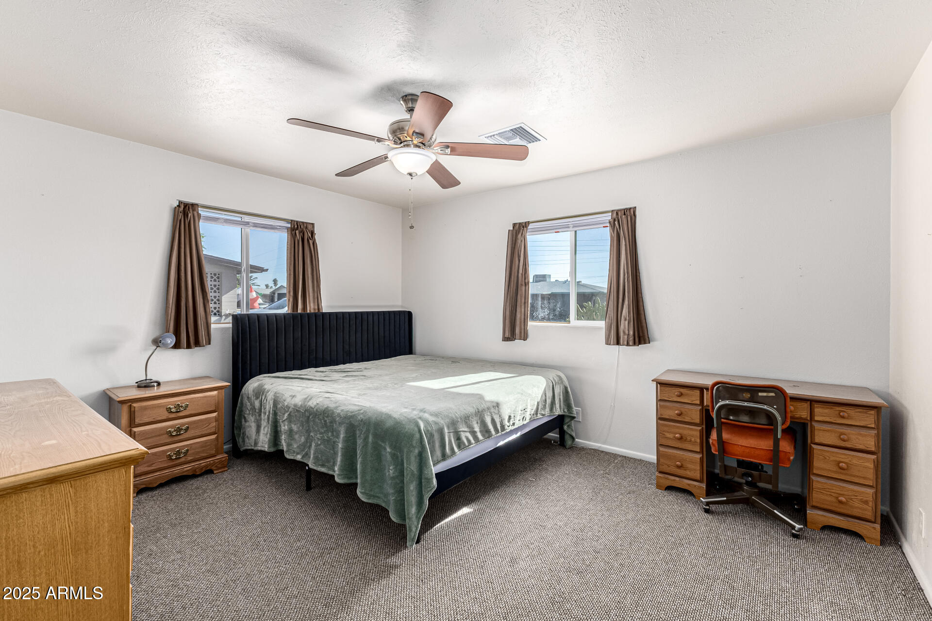 6256 East Decatur Street Mesa, AZ 85205 - Photo 19 of 28 a bedroom with a bed and a ceiling fan