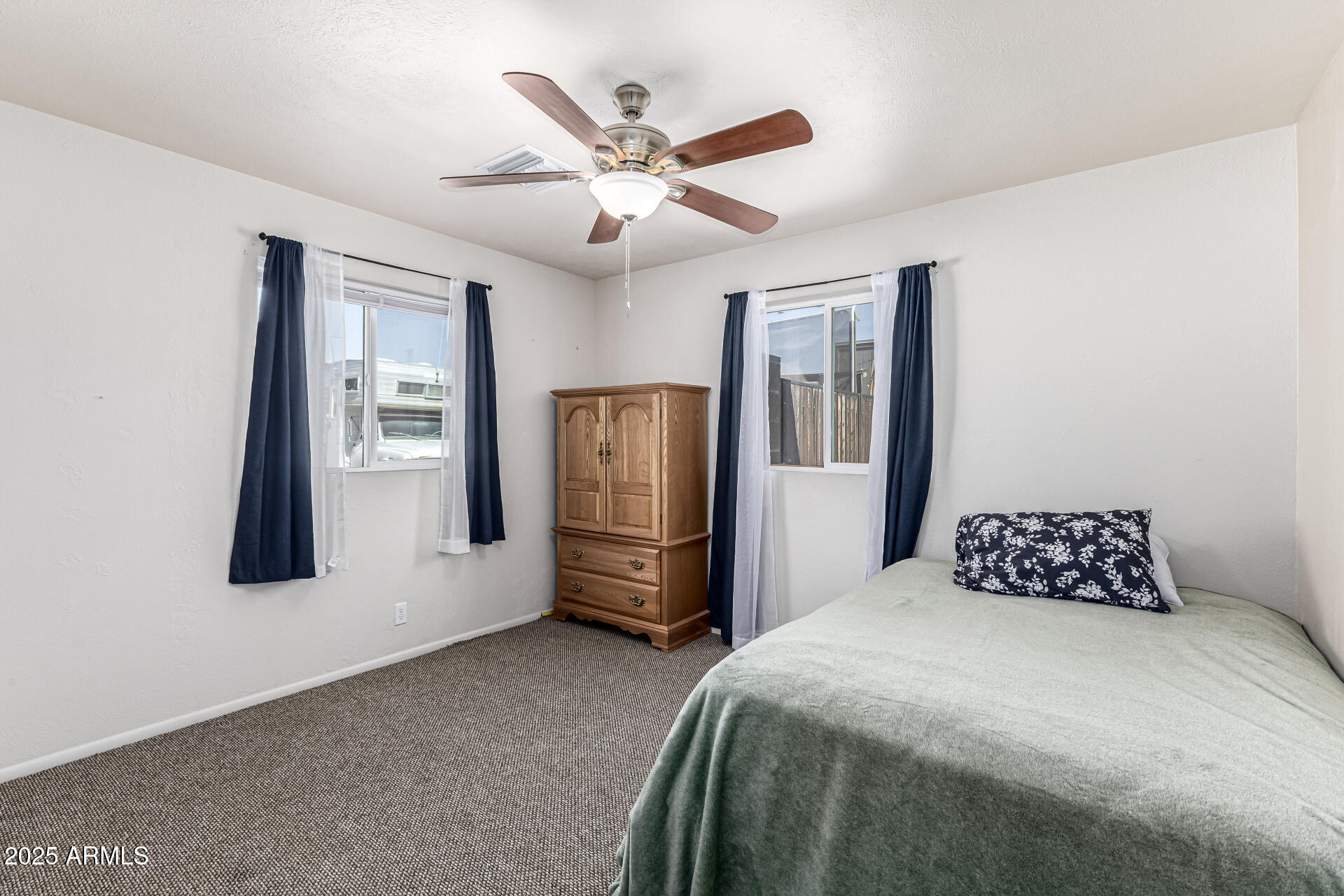 6256 East Decatur Street Mesa, AZ 85205 - Photo 21 of 28 a bedroom with a large bed and a ceiling fan