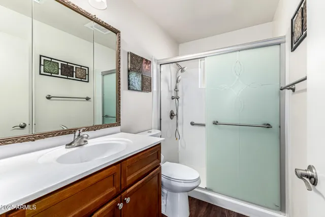 a bathroom with a sink a toilet and shower