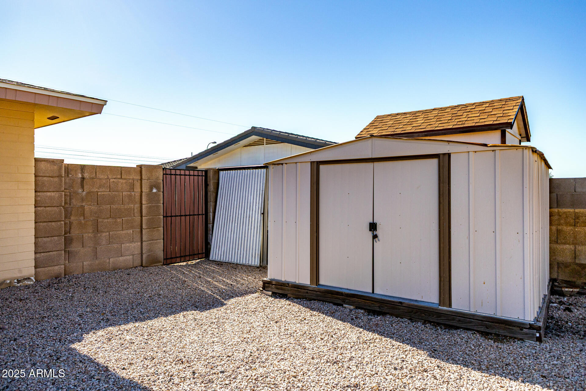 6256 East Decatur Street Mesa, AZ 85205 - Photo 26 of 28 a view of house with garage and wooden fence