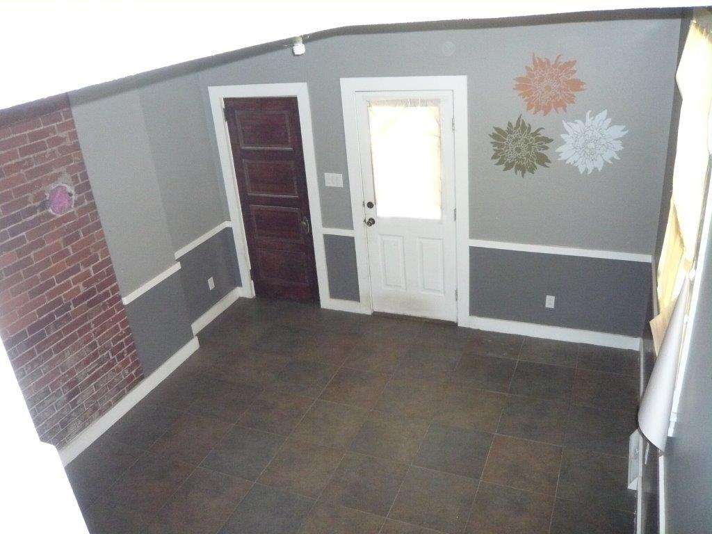 632 Blackburn Road Sewickley, PA 15143 - Photo 6 of 16 The owners used this room as their dining room. Door on right to rear porch, door on left to full bath. View from landing of the staircase.