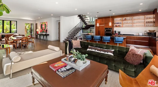 a living room with furniture and large windows