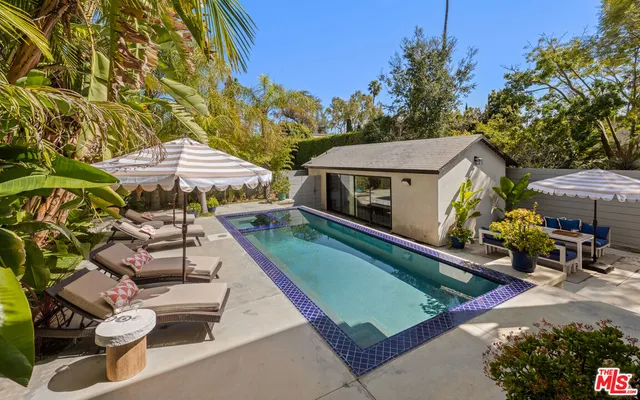 a view of a patio with swimming pool table and chairs