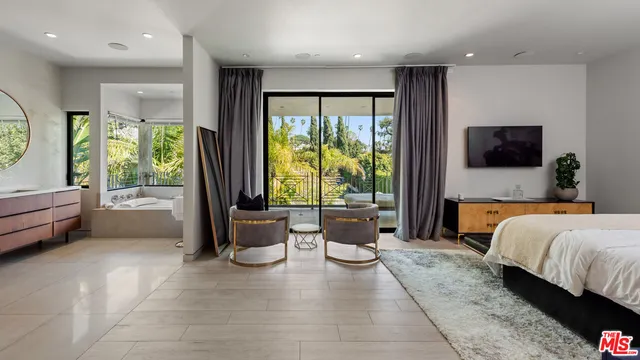 a spacious bedroom with a large bed and a large window