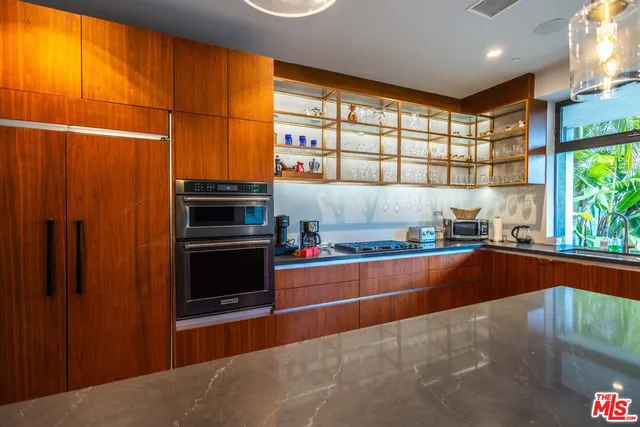 a kitchen with stainless steel appliances a refrigerator and a stove top oven