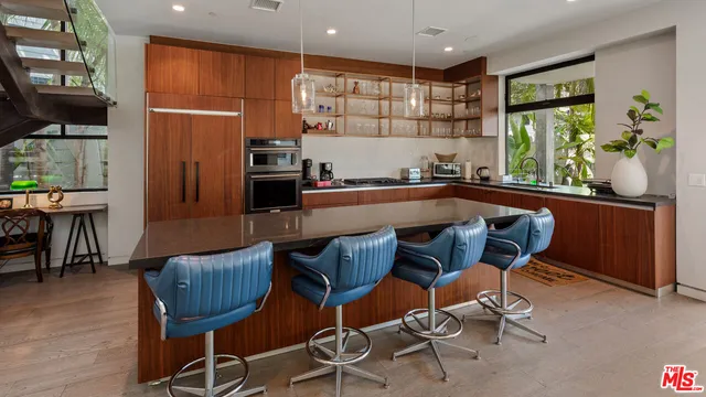 a kitchen with a table chairs refrigerator and microwave