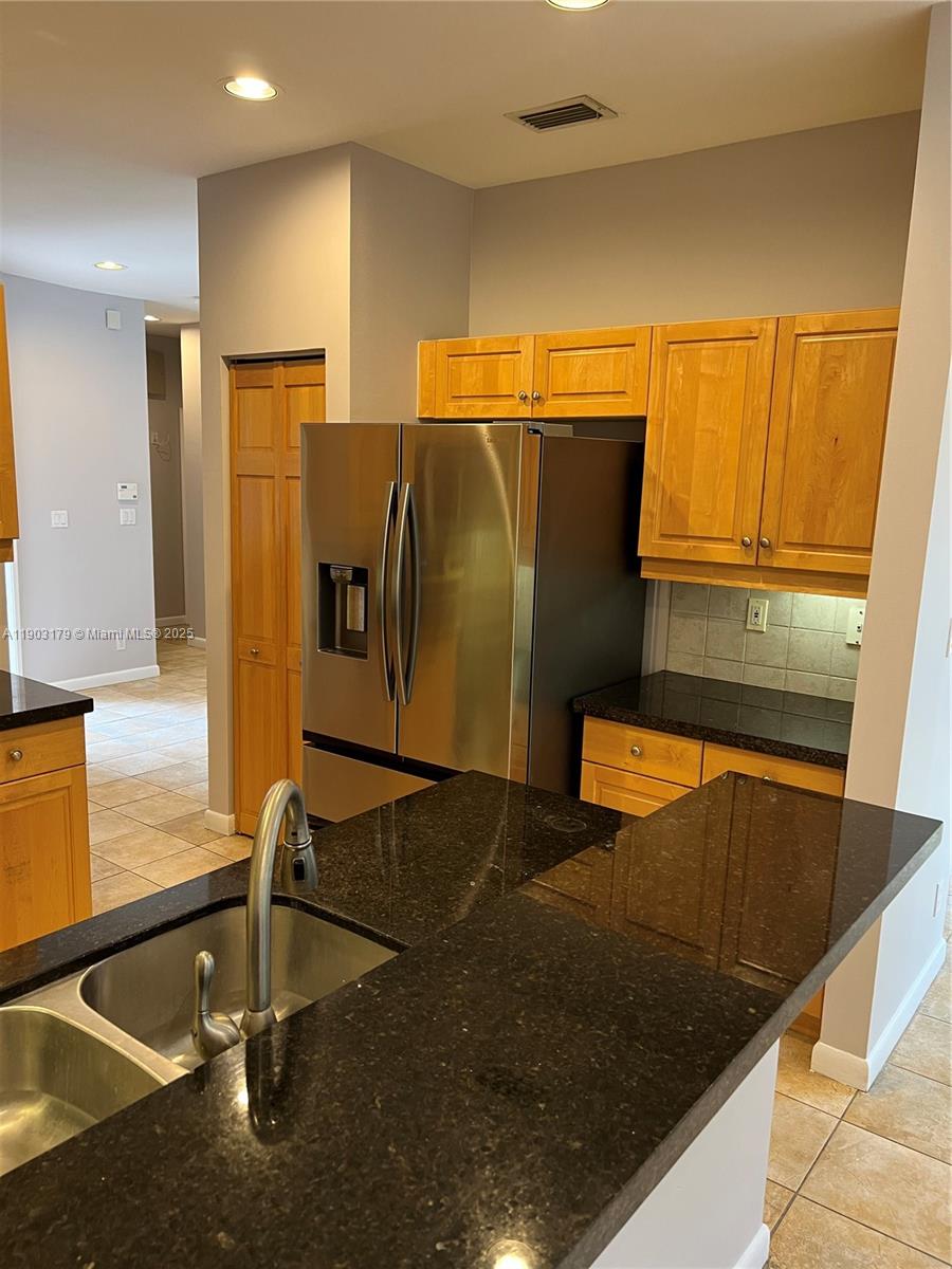 15827 Southwest 12th Street, Unit 15827 Pembroke Pines, FL 33027 - Photo 2 of 6 a view of a kitchen with refrigerator and microwave