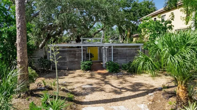 a view of house with backyard and outdoor seating