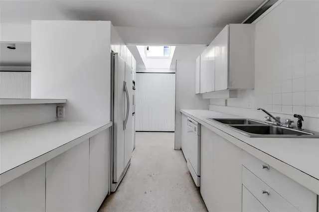 a kitchen with a sink and refrigerator