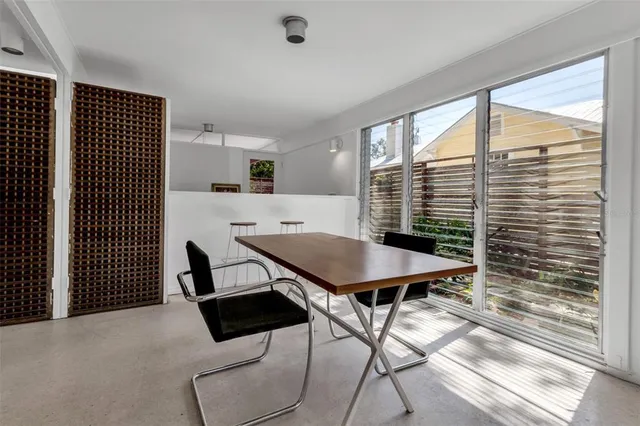 a view of a dining room with furniture and window