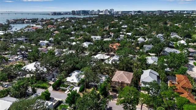 an aerial view of a house with a yard and lake view
