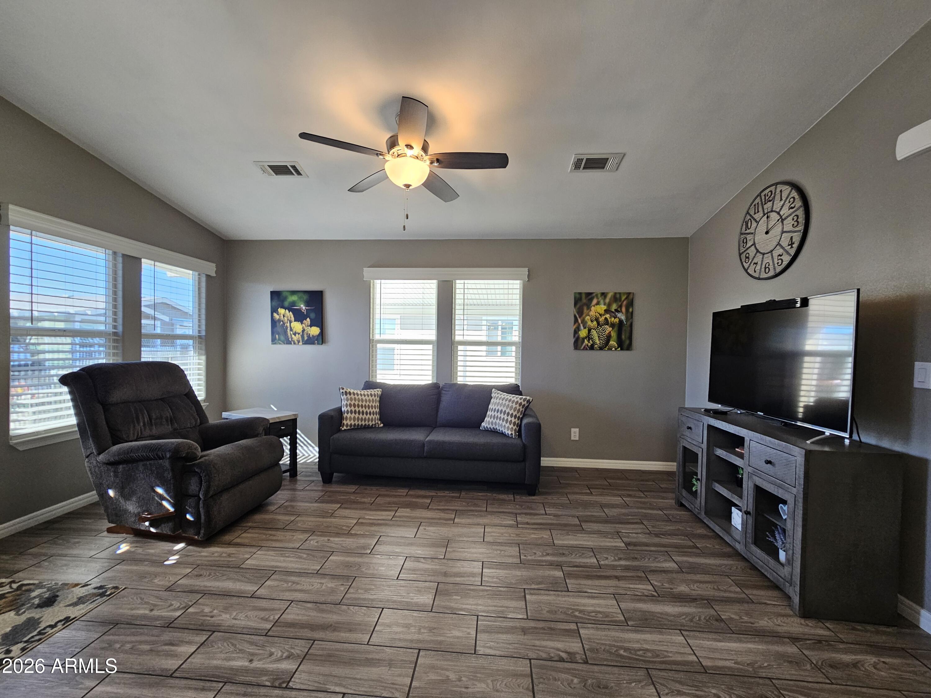650 North Hawes Road, Unit 3516 Mesa, AZ 85207 - Photo 17 of 37 a living room with furniture and a flat screen tv