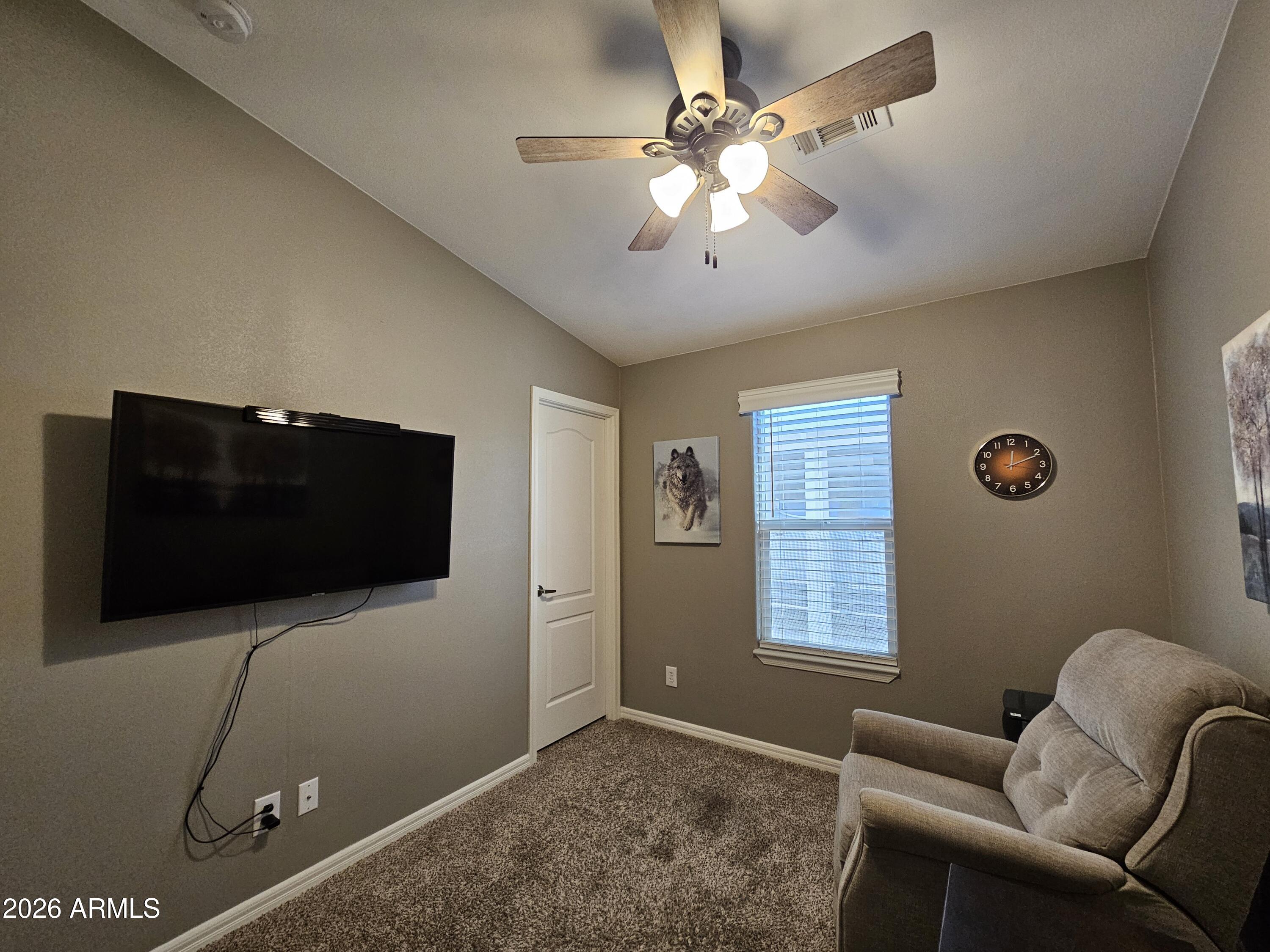650 North Hawes Road, Unit 3516 Mesa, AZ 85207 - Photo 21 of 37 a living room with furniture and a flat screen tv