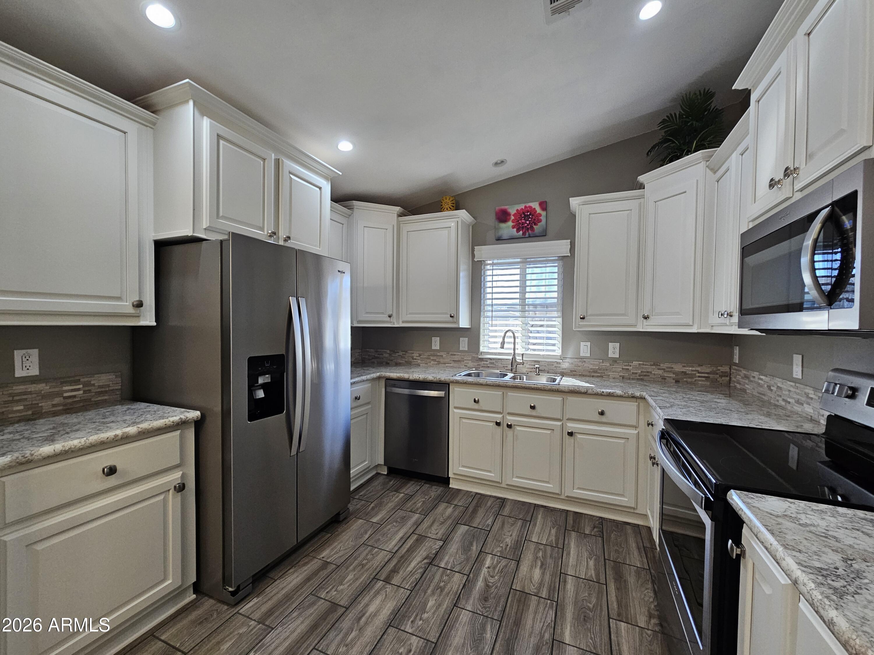 650 North Hawes Road, Unit 3516 Mesa, AZ 85207 - Photo 3 of 37 a kitchen with a sink stove and refrigerator
