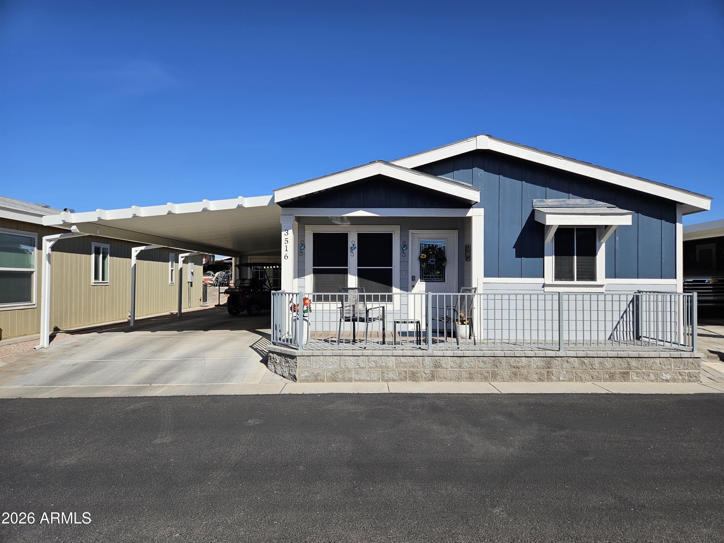 650 North Hawes Road, Unit 3516 Mesa, AZ 85207 - Photo 7 of 37 a front view of a house with a porch